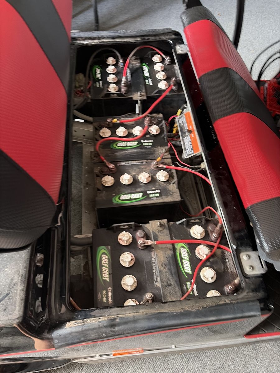 Old lead-acid golf cart battery bank under the seat before upgrade